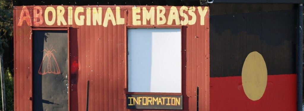 Bildausschnitt aus der Baracke, die beschriftet ist mit "original embassy".  - In der Botschaft residiert der Botschafter.