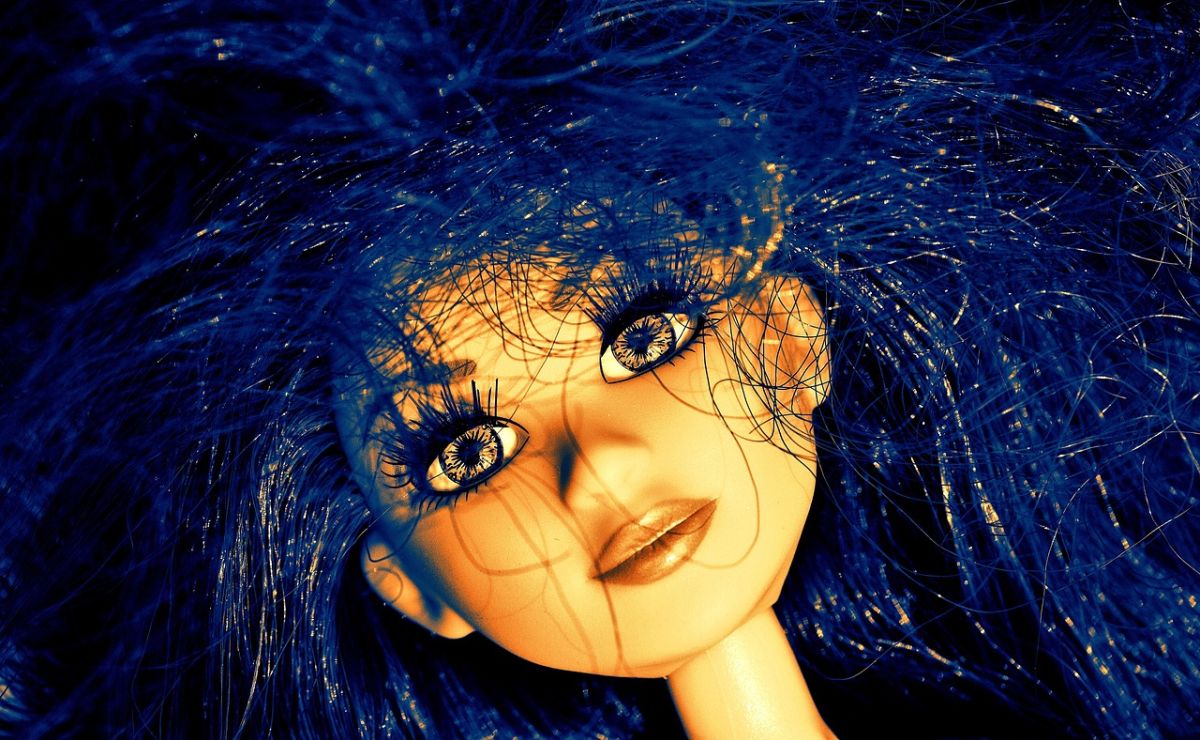 Puppe mit blauen Haaren und großen Augen.